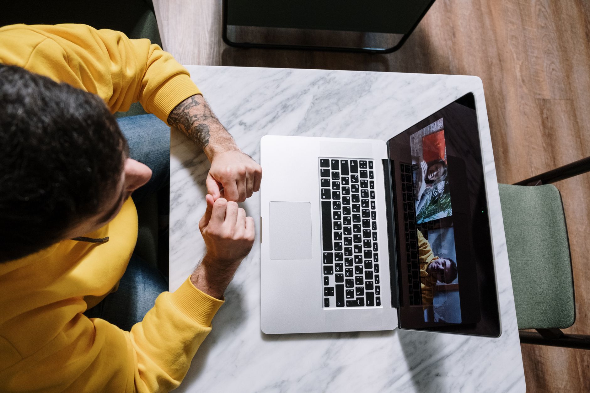 Person screen sharing a Bible app on a laptop during a virtual group meeting
