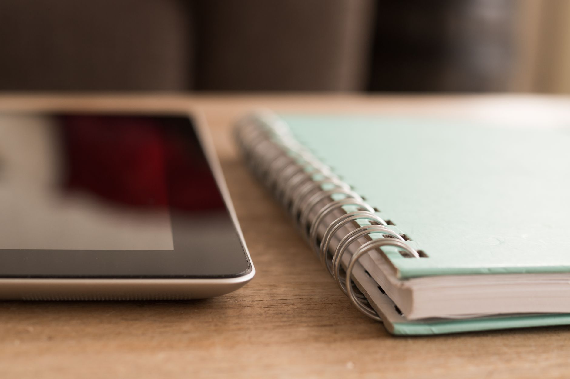 Person studying Bible with cross-reference chart on a tablet and notebook