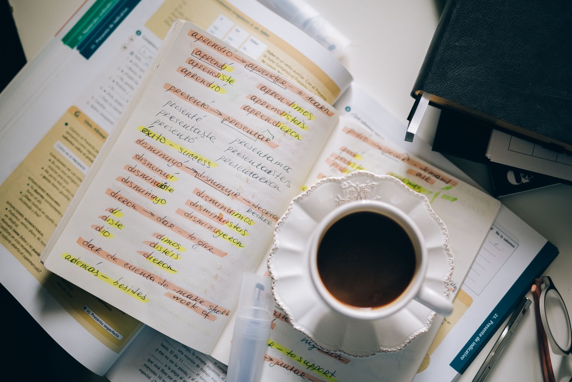 Open Bible with multiple translation bookmarks on a wooden desk