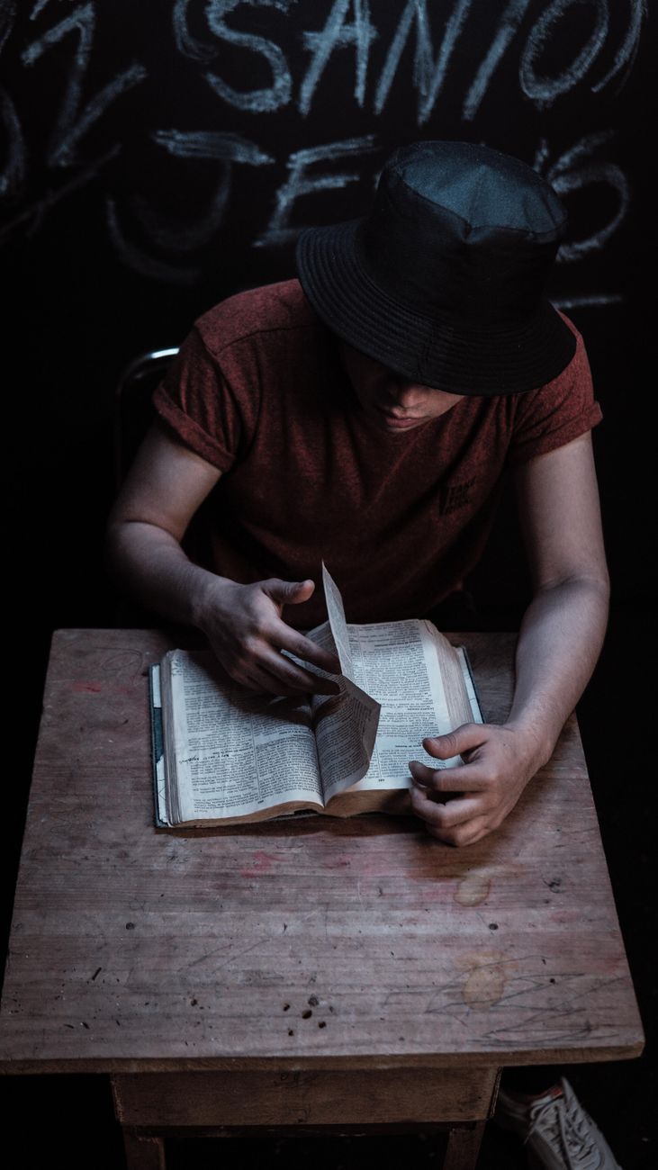 Person using an Android phone to study the Bible with a coffee cup nearby