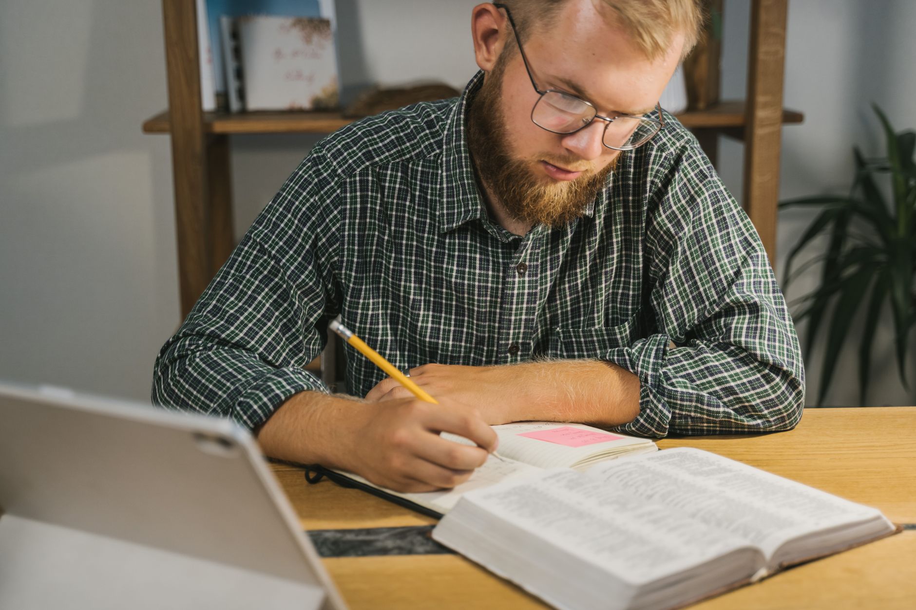 Open Bible with highlighted cross references and study notes on a wooden desk