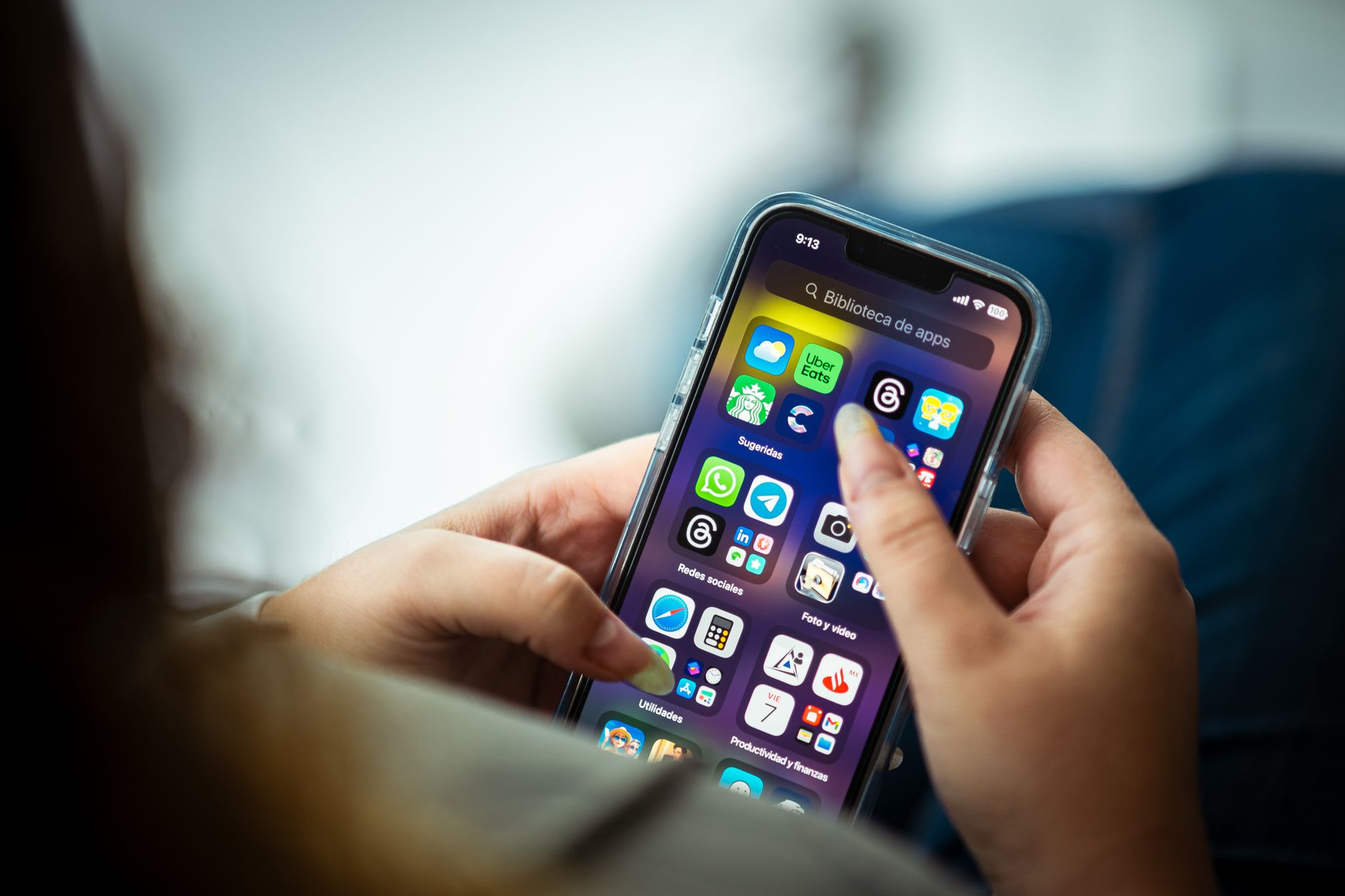 Person reading Bible on a smartphone with study notes open