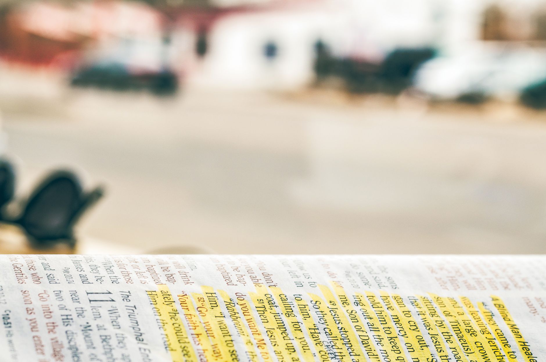 Open Bible with highlighted verses and a magnifying glass symbolizing misinterpretation