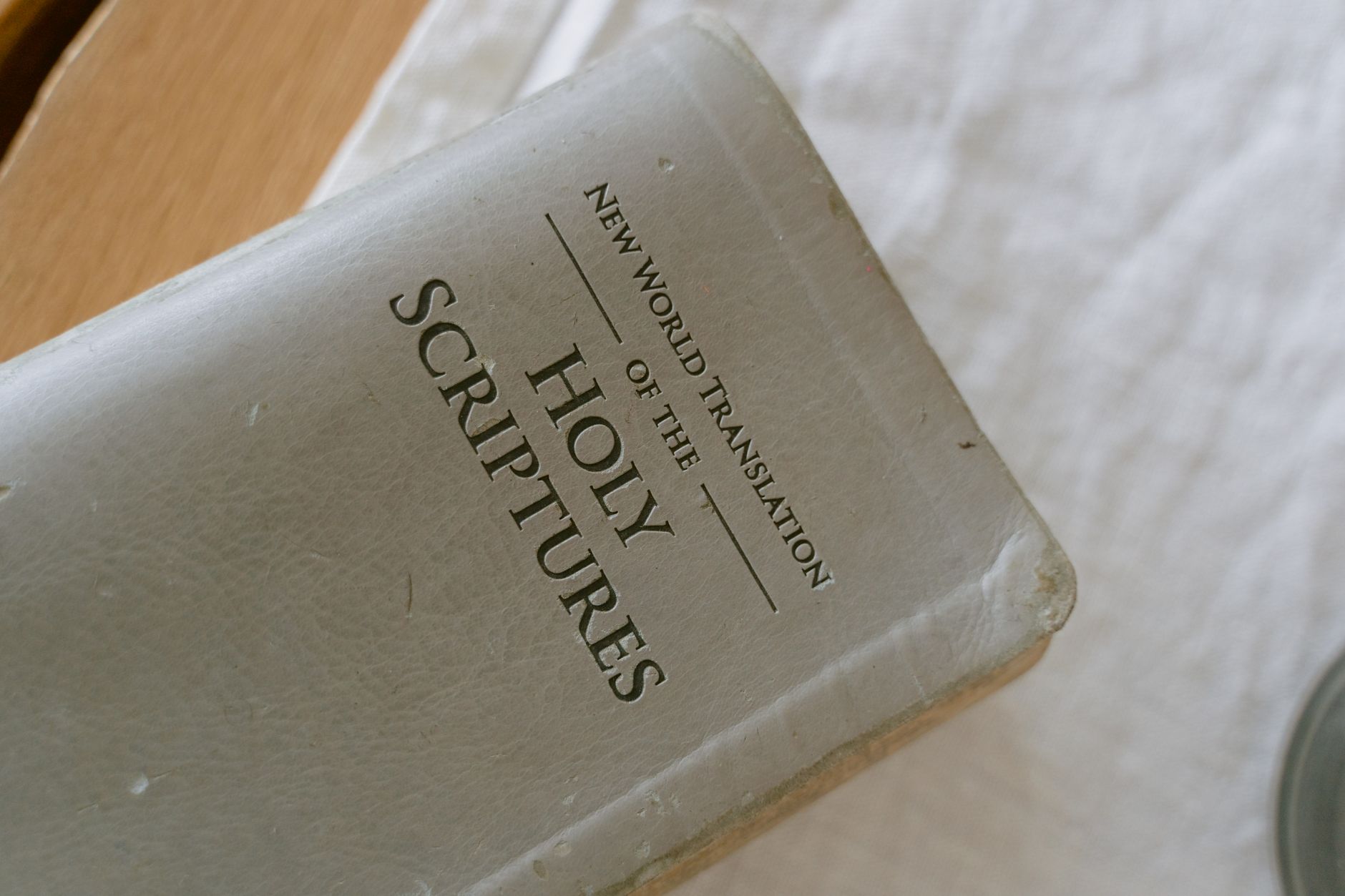 Person reading multiple Bible translations side by side on a desk