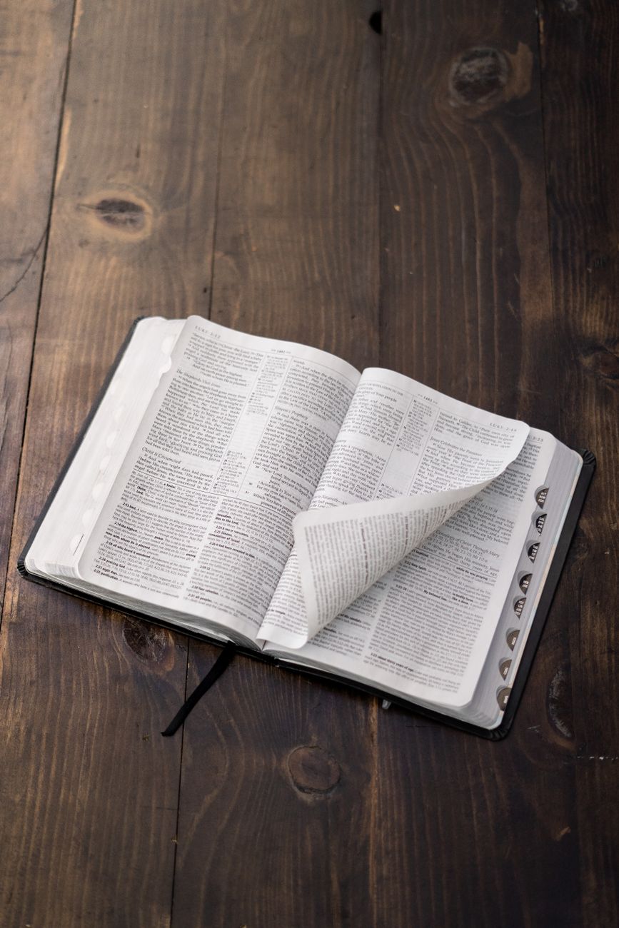 Open Bible with study notes and cross-reference tools on screen