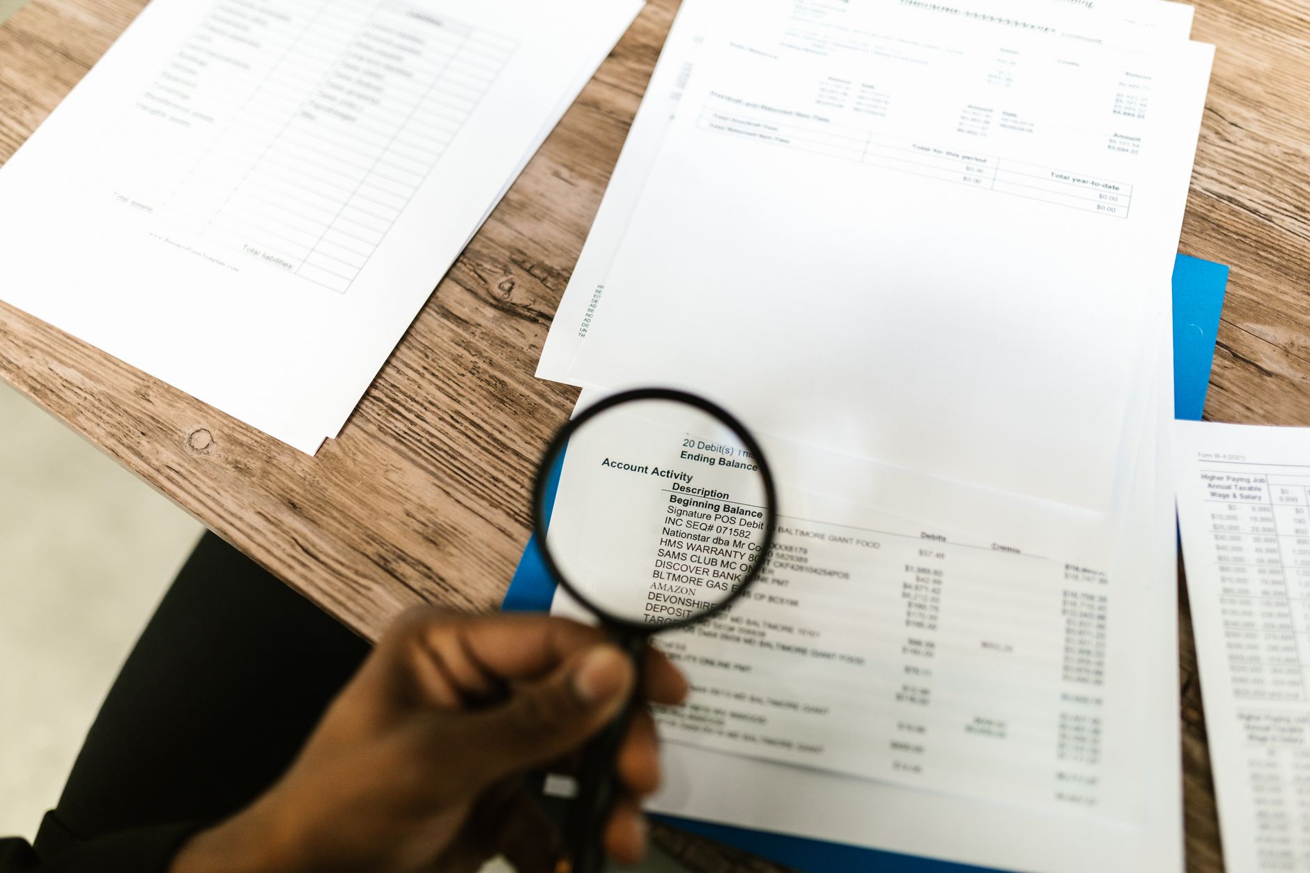 Magnifying glass over a printed document showing careful review of a Bible plan