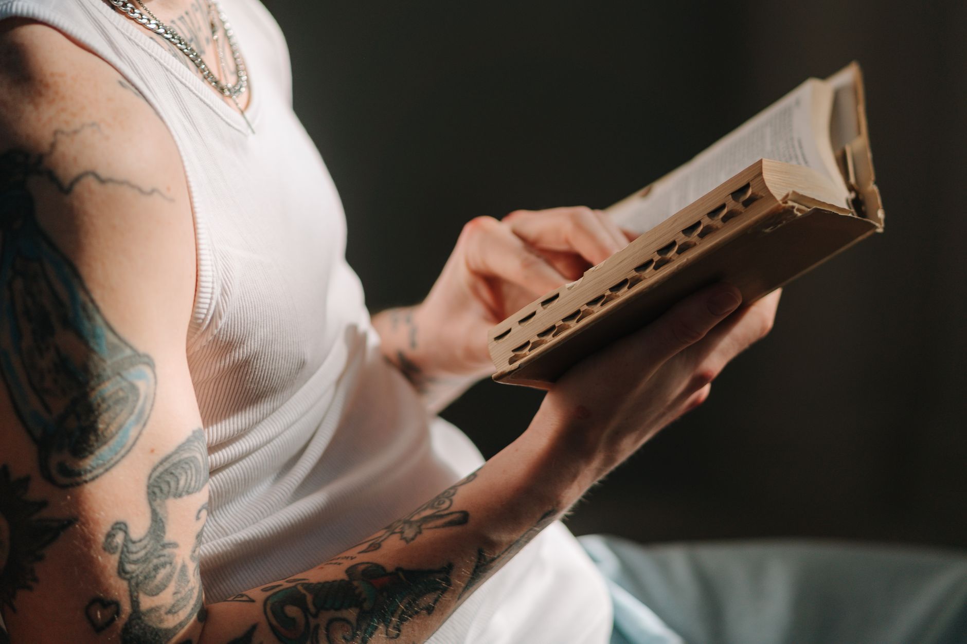 Person reading the Bible on a smartphone with a coffee cup nearby