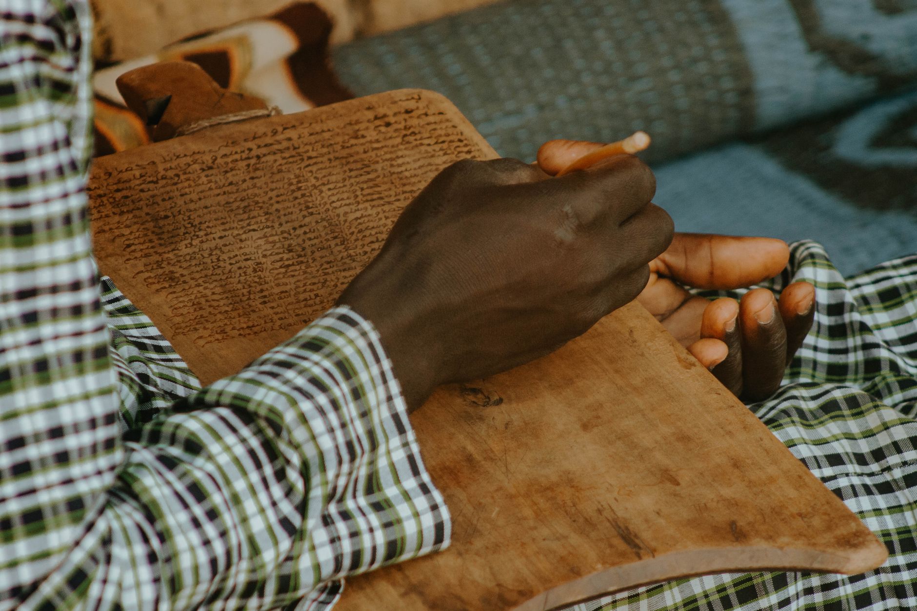 Scholar studying ancient Bible manuscript with magnifying glass and notes