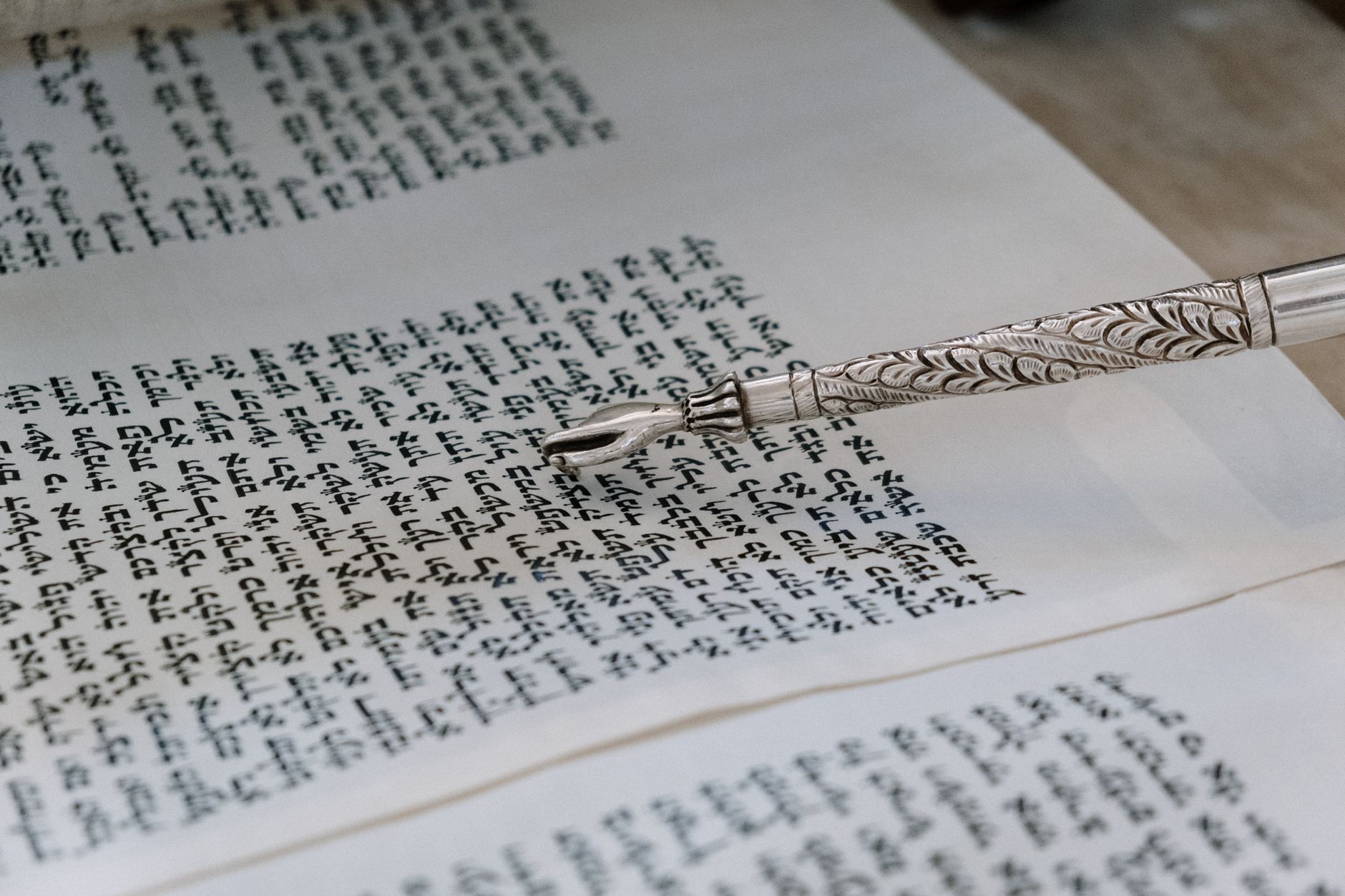 Open Bible with ancient manuscript pages showing Jeremiah text
