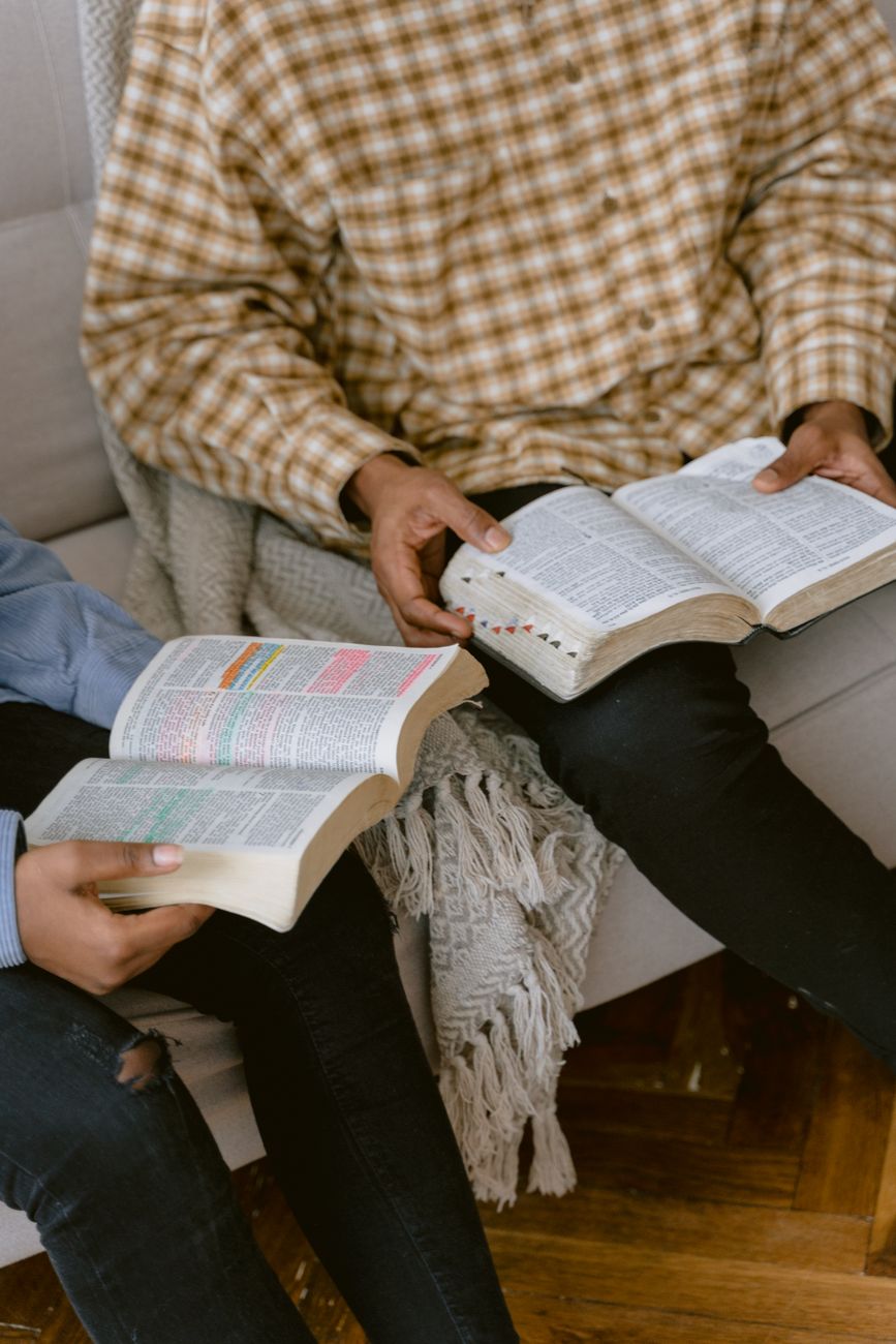 Open Bible with study notes and highlighted verses on a table