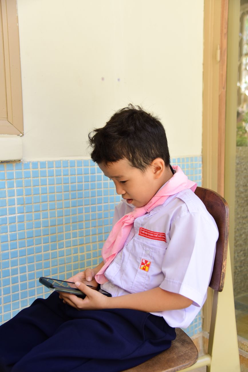 Student taking a digital quiz on a tablet for Bible learning