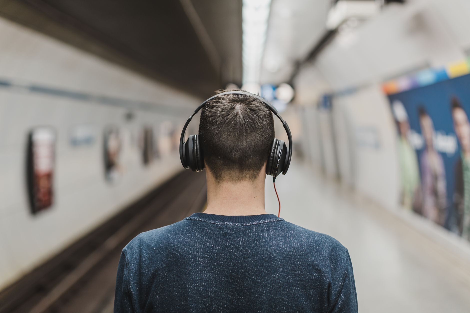 Person listening to audio Bible app with headphones