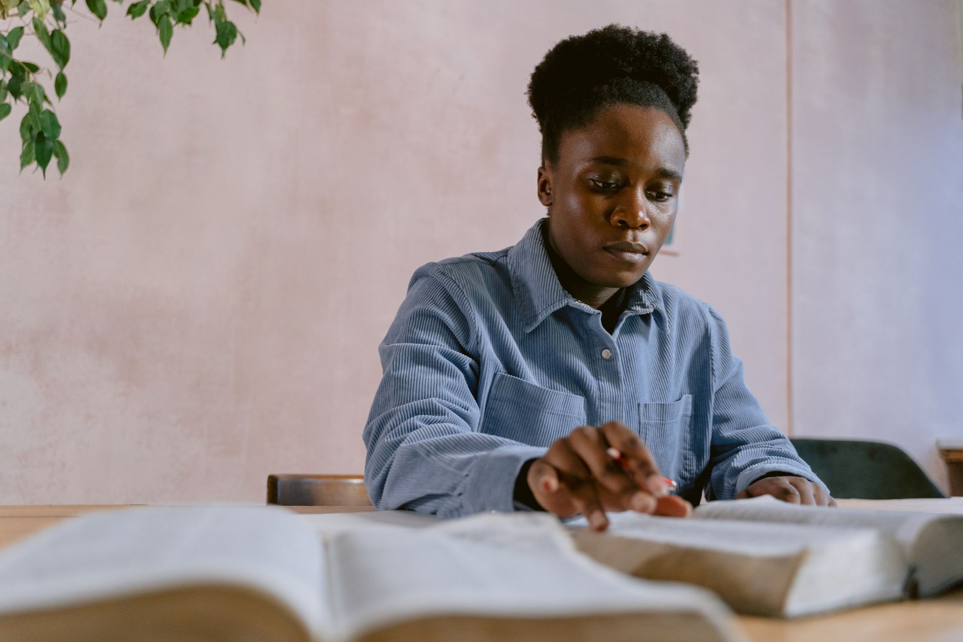 frustrated person reading bible at desk