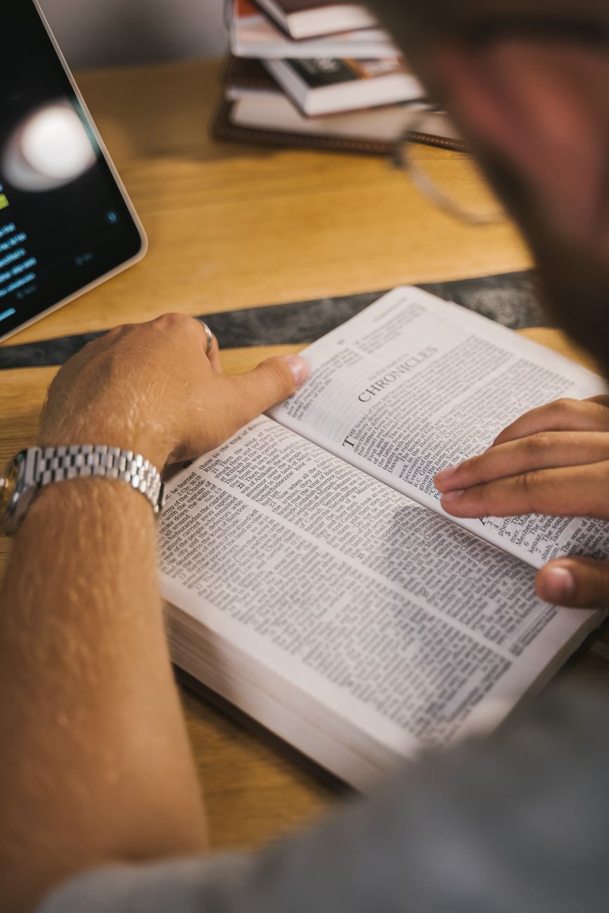 Bible study app showing scripture analysis with historical context and reading plans on a smartphone