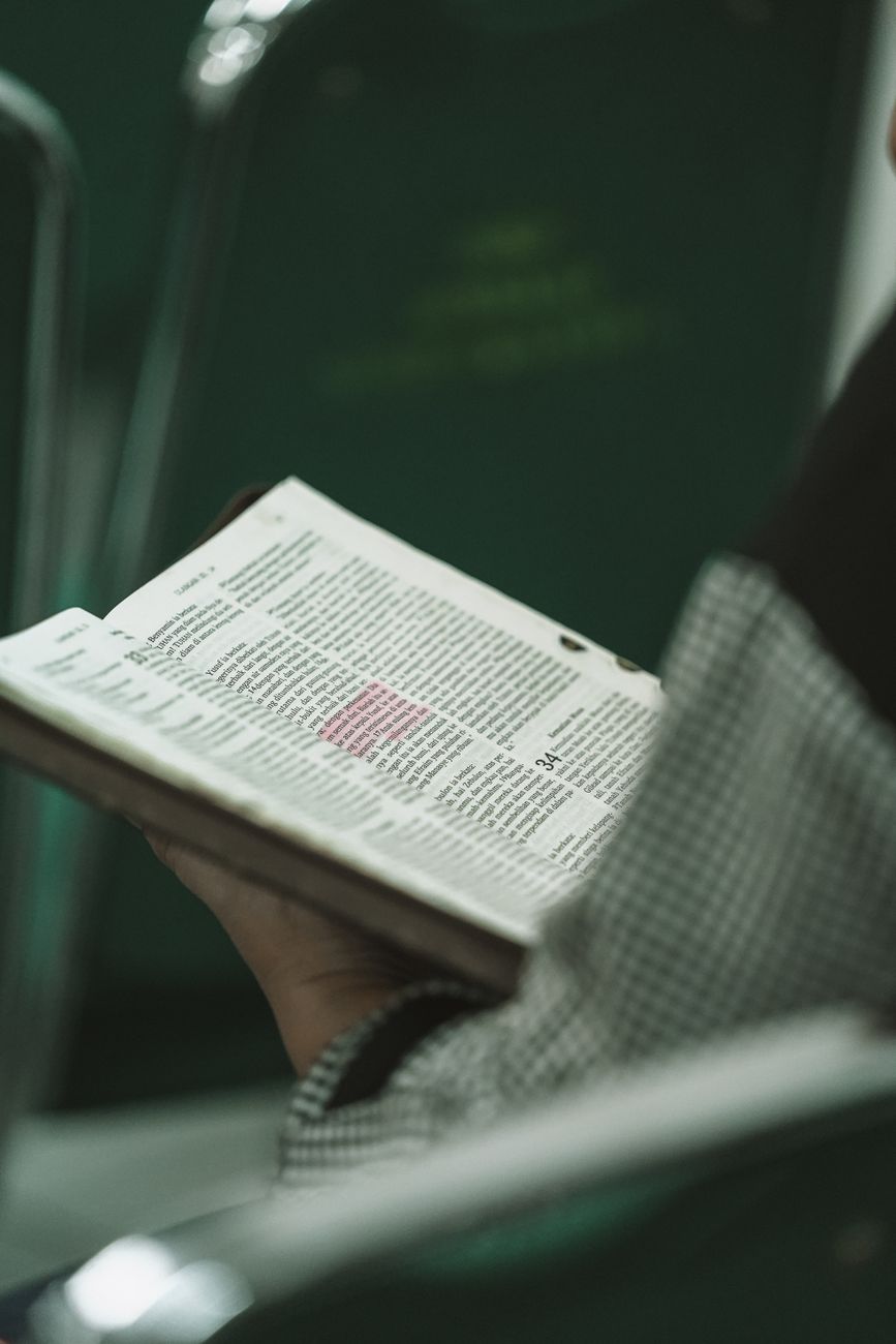 Close-up of a person highlighting a Bible verse with a yellow marker