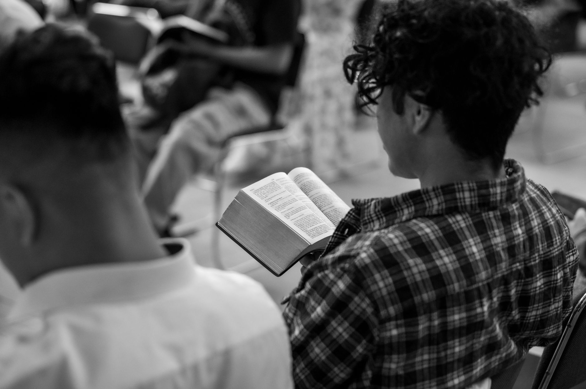 Teenager studying Bible with notebook and highlighter